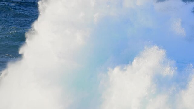 Cinematic aerial of massive Atlantic waves crashing on Gran Canaria coast with dangerous swell and red flag sea conditions