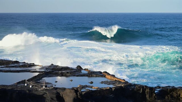 Cinematic aerial of massive Atlantic waves crashing on Gran Canaria coast with dangerous swell and red flag sea conditions