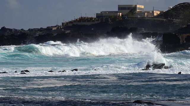 Cinematic aerial of massive Atlantic waves crashing on Gran Canaria coast with dangerous swell and red flag sea conditions