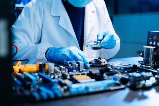 Professional technician repairing hard drive for data recovery in modern technology lab. Digital storage, cybersecurity, hardware repair and data protection concept.