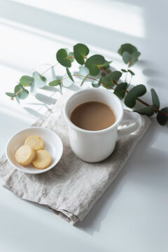 Vertical Minimal Coffee and Cookies with Eucalyptus in Soft Morning Light