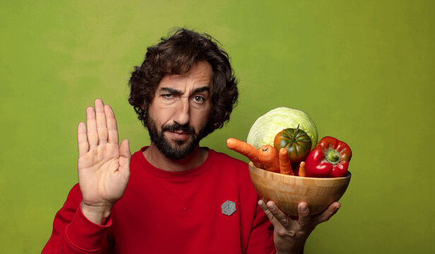 young adult bearded man with vegetables