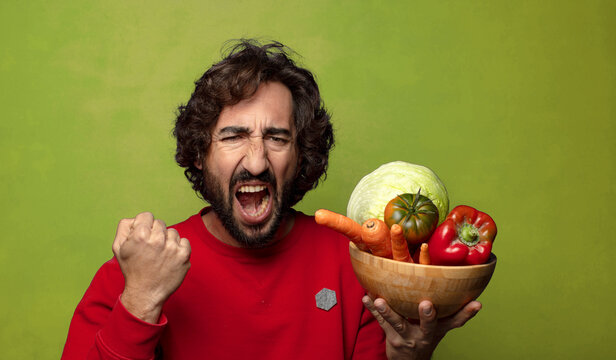 young adult bearded man with vegetables