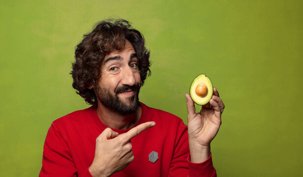 young adult bearded man with an avocado