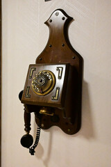 antique vintage analog telephone dialing or scrolling phone on old wall. Contact us concept