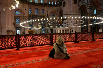 woman in a headscarf inside the Blue Mosque in Istanbul.