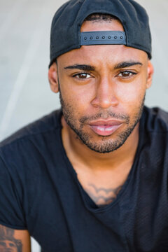 Portrait of serious young man with stubble wearing basecap