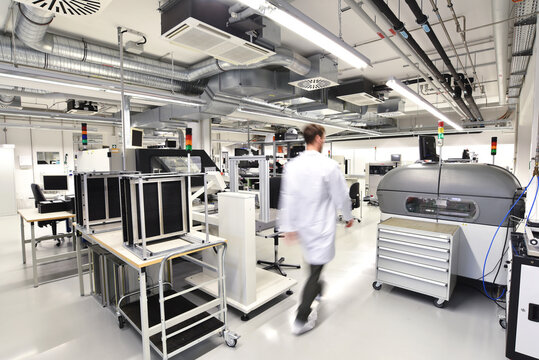 Man walking in a factory for manufacturing of circuit boards for the electronics industry