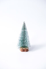 Miniature winter pine tree with snow. Festive christmas and holiday atmosphere, isolated on white background