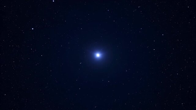 A deep space image showing a bright celestial object emitting a brilliant white light. Many smaller stars of different brightnesses dot the dark expanse