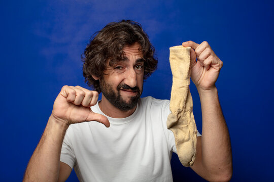 young adult bearded man with a dirty sock