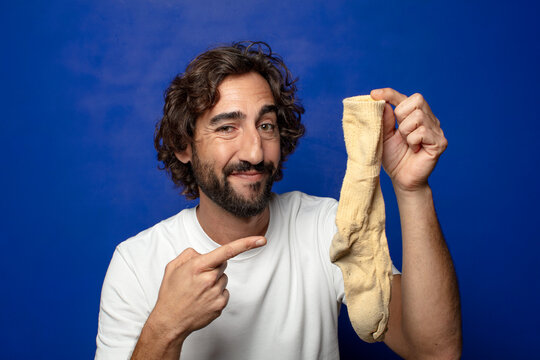 young adult bearded man with a dirty sock