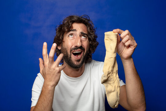 young adult bearded man with a dirty sock