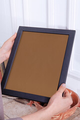 In the decorative background, a woman is holding a picture frame.