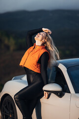 Young Woman With Sports Car at Sunset