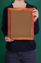 In the decorative background, a woman is holding a picture frame.