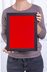 In the decorative background, a woman is holding a picture frame.