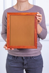 In the decorative background, a woman is holding a picture frame.