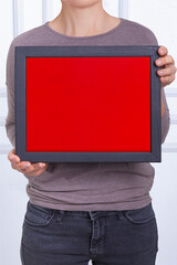 In the decorative background, a woman is holding a picture frame.