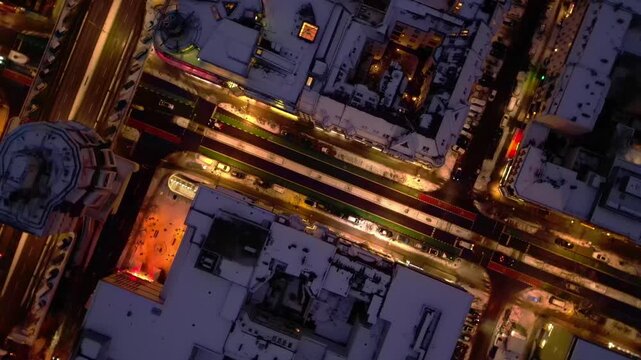 Berlin illuminating shopping street snowed at night. Unique aerial view drone