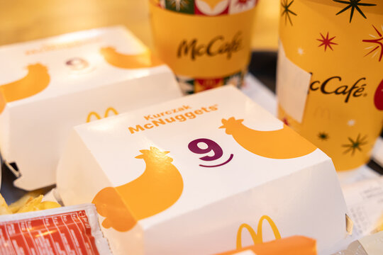 Poznan, Poland - November 19, 2025: McDonald's Kurczak McNuggets box, displaying the number 9, with McCafe drinks, defining popular fast food and convenient restaurant dining