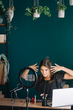 Young woman making a makeup video tutorial