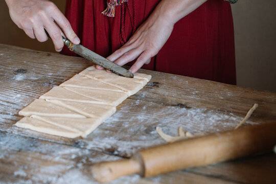 Close-up of woman preparing dough for croissants