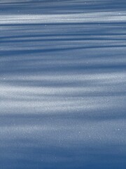 Obraz premium Winter abstract background with shadows on the snow