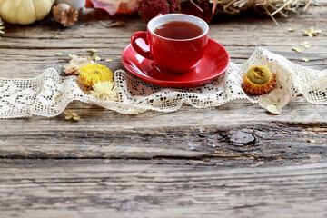 Hot tea on the table, against the background of beautiful autumn decorations.
