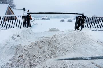 Removing snow drifts from the parking lot.