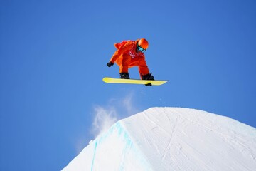 Snowboarder performing trick in halfpipe collage with snow splash. Concept of creativity, adrenaline sport, lifestyle branding, youth energy.