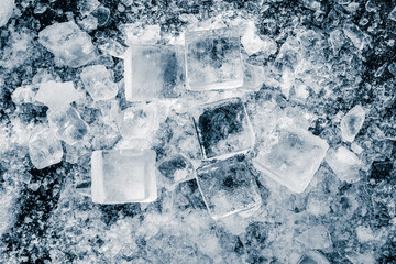 Ice cubes with a ice crush and snow on black background.