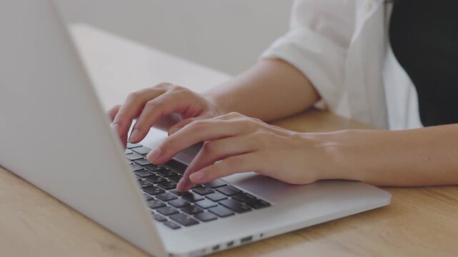 Close-up of Hands Typing on Laptop at Home