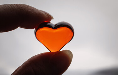 Red heart in hand for Valentine's Day as a background for the holiday
