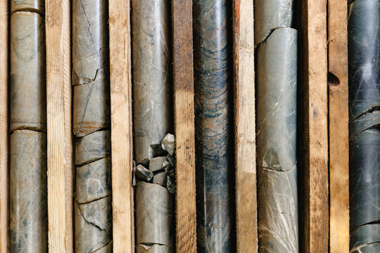 Geological rock core samples in wooden crates displaying various textures and patterns top view