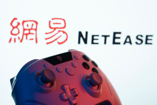Dhaka, Bangladesh- 20 Mar 2025: A close-up of a gamepad with the NetEase seen on screen in the background.