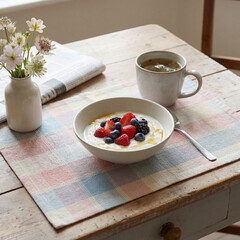 Soft pastel breakfast with yogurt, berries, and tea, gentle mood