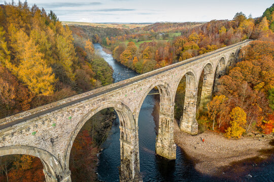 Lambley Viaduct straddling the River South Tyne in Northumberland, on a clear day in Autumn, taken by drone
