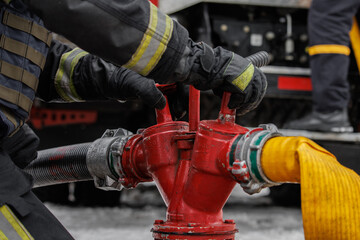 Firefighter Connecting Hoses to Fire Hydrant