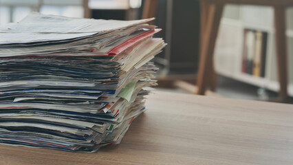 Pile of paperwork on office desk