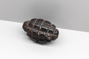 Naklejka premium Soviet F-1 hand grenade is on white shelf