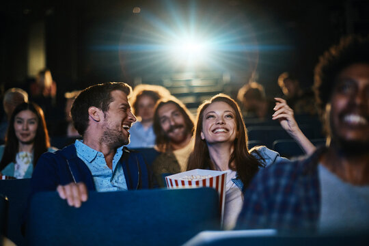 Friends watching a movie in a cinema theater