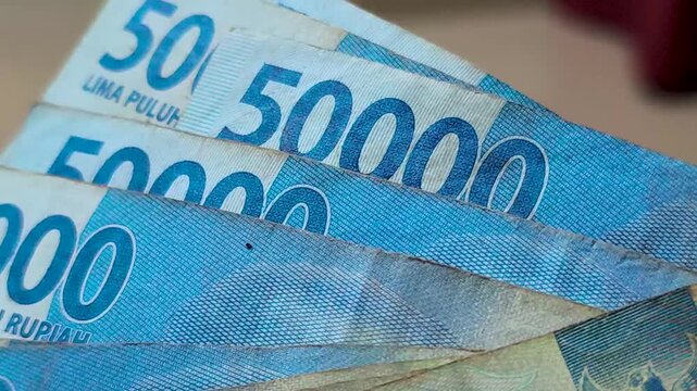 Close up of the fifty thousand rupiah figure on an Indonesian banknote