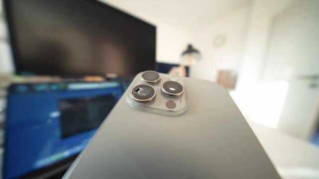Broken smartphone camera lens in dramatic ultrawide closeup, cinematic view of modern technology failure, consumer risk, fragility, and the cost of digital life