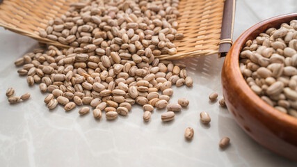 Brazilian beans in a container and spread out on the table. Background image. 