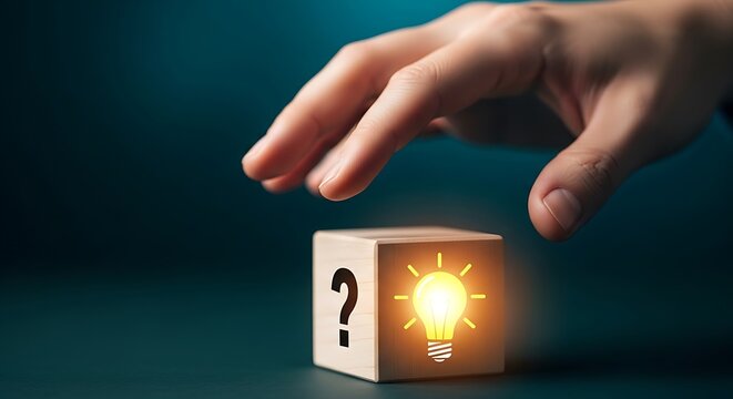 Hand touching wooden block with glowing light bulb and question mark