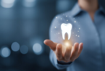 a man's hand holding a glowing tooth symbol on a dark background, dental treatment concept