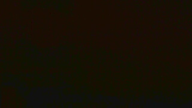 A stone ceiling in a dark cellar or old basement with a glowing industrial lamp and thick cobwebs