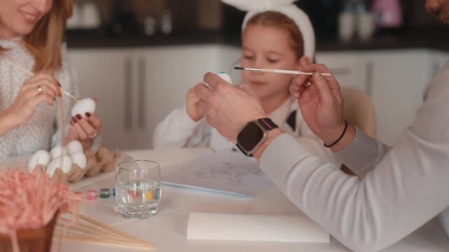 Happy Family Painting Easter Eggs Together for a Joyful Holiday Celebration