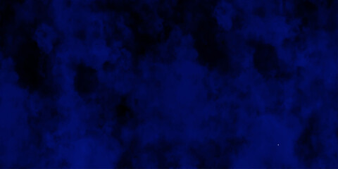 Artificial magic smoke in black and blue light on black background in darkness. light blue and dark blue background. Black and blue Grunge Concrete Wall Texture Background.